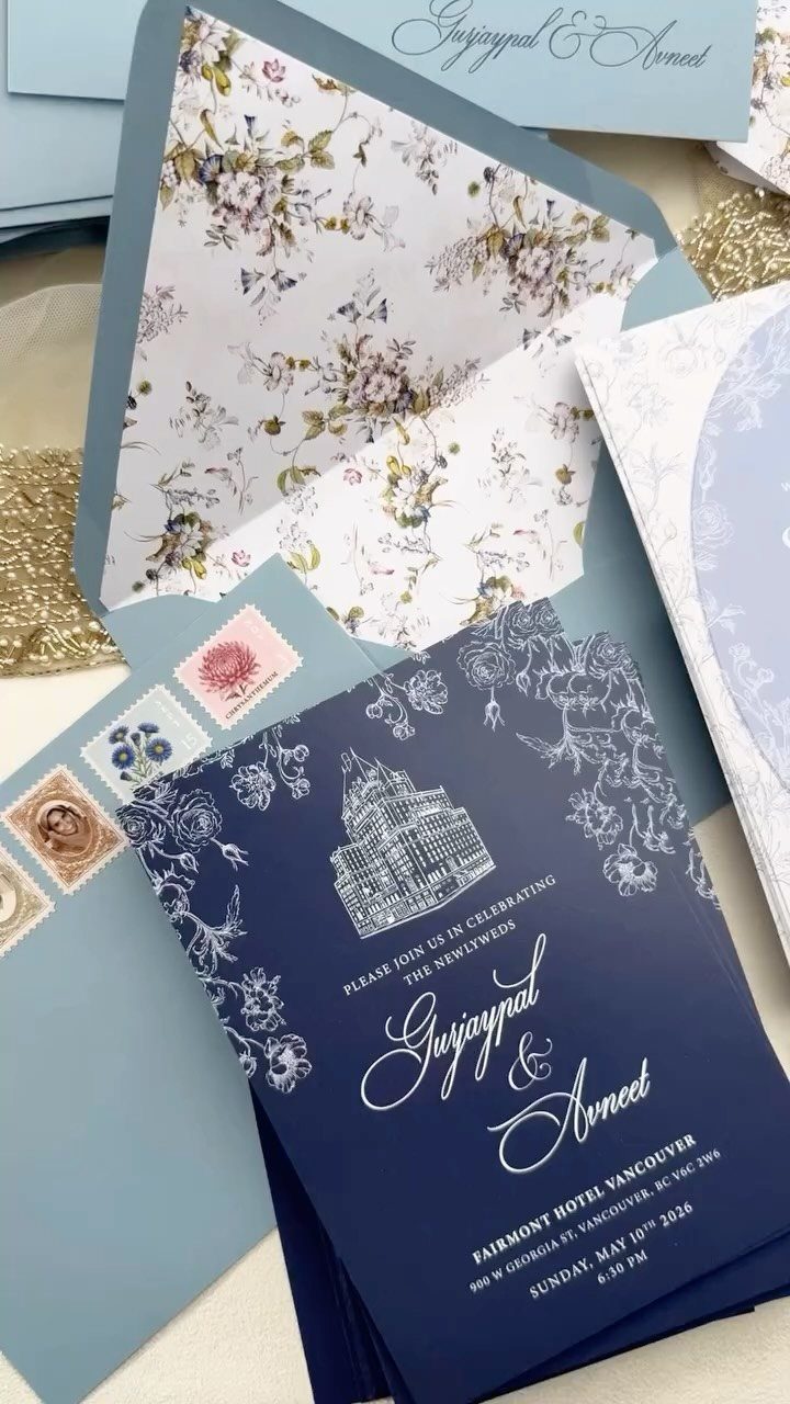 Navy blue wedding invitation with white calligraphy and floral lining in blue envelope