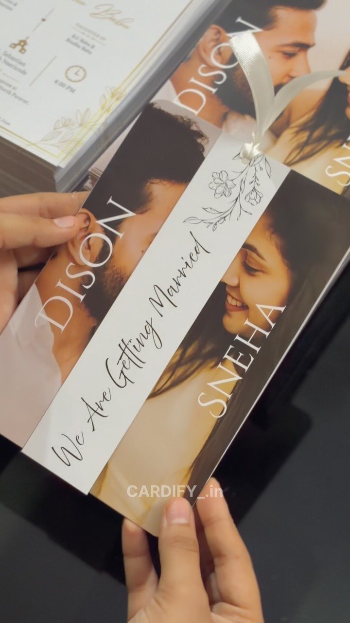 Wedding invitation card featuring a photo of a couple with elegant gold text.