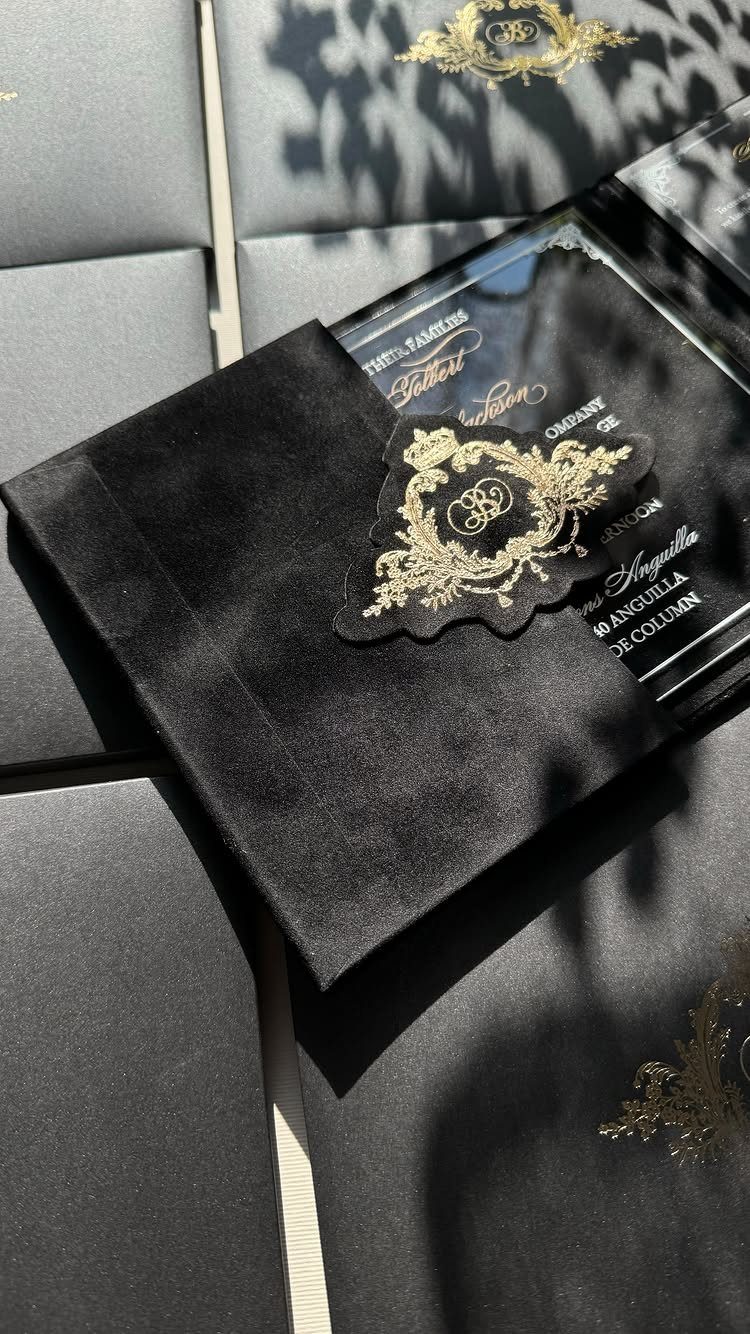 Black velvet envelope with a clear acrylic wedding invitation and gold foil details.