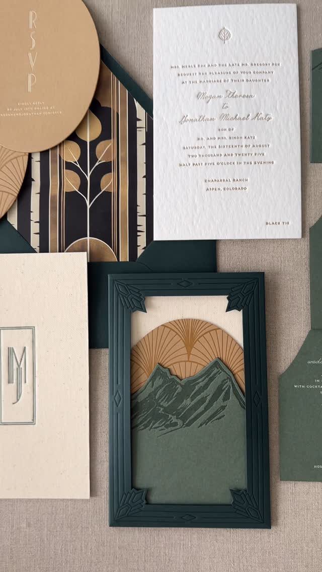 Wedding invitation suite with forest green and gold Art Deco mountain landscape design.