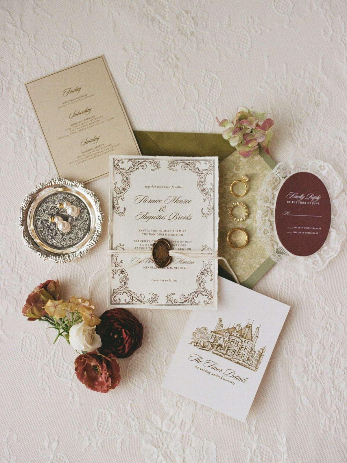 Vintage wedding invitation suite with wax seal and floral accents on lace fabric