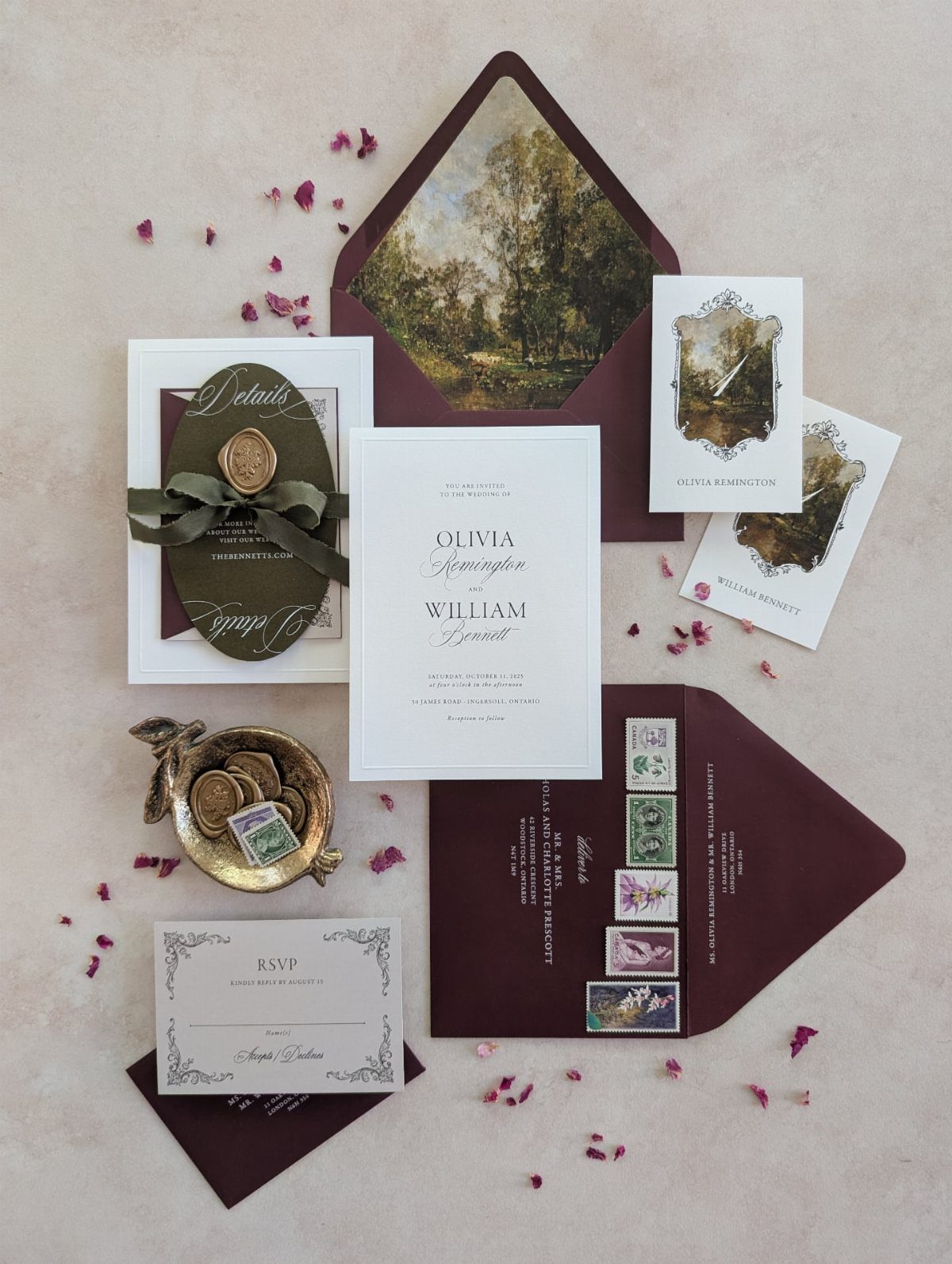 Wedding invitation suite with dark green pocket fold, burgundy envelopes, and wax seal.