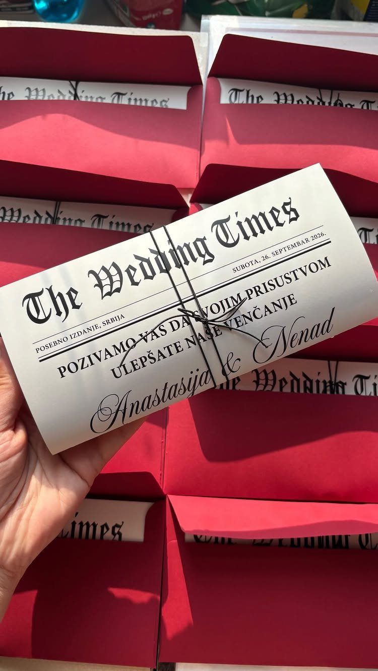 Wedding newspaper invitation titled The Wedding Times tied with black string in red envelopes