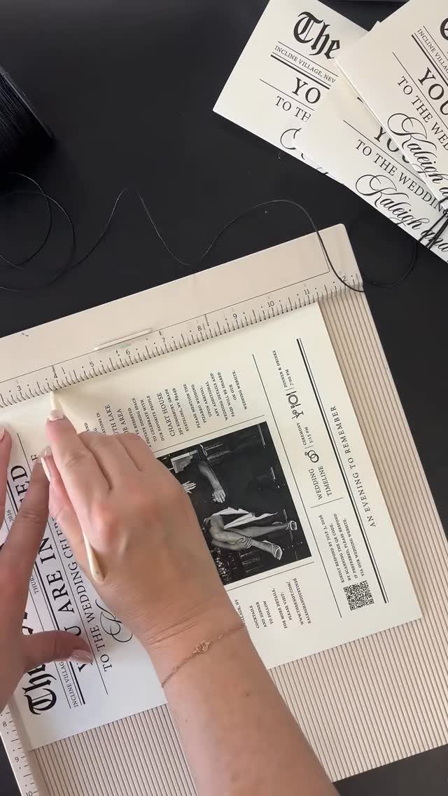 Wedding newspaper invitation with black and white photo being prepared on a mat.