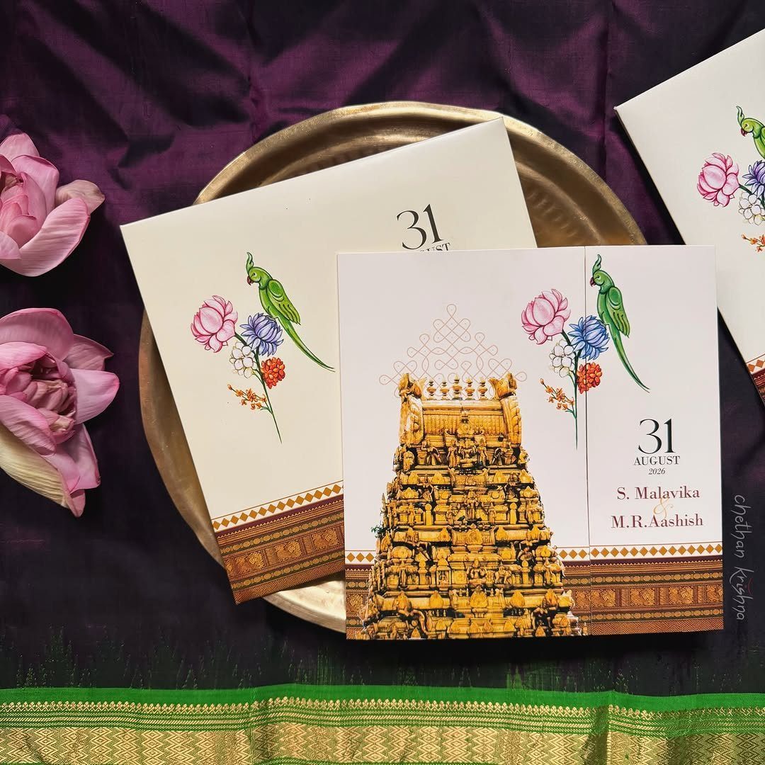 Folded wedding programs with temple and floral art on a gold plate.