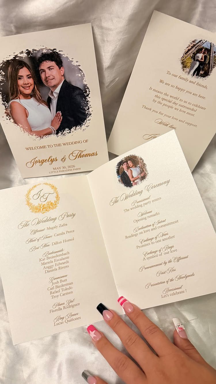 Wedding program booklets featuring photos of the couple and gold printed ceremony details.