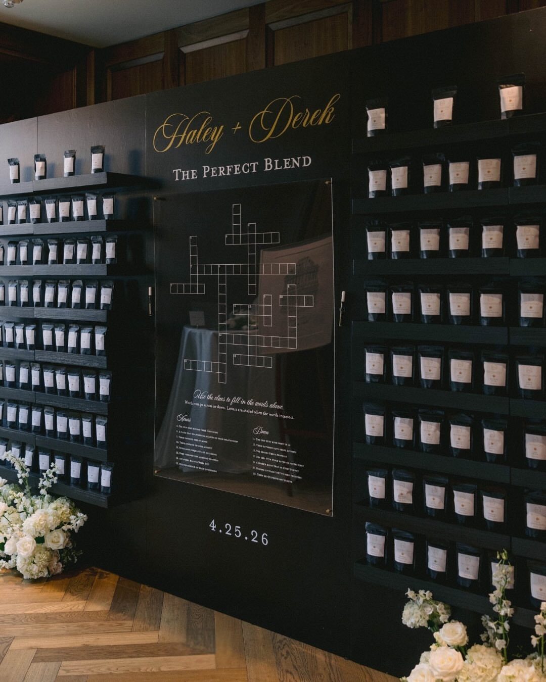 Rows of small white coffee bags on a black wall with a crossword puzzle.
