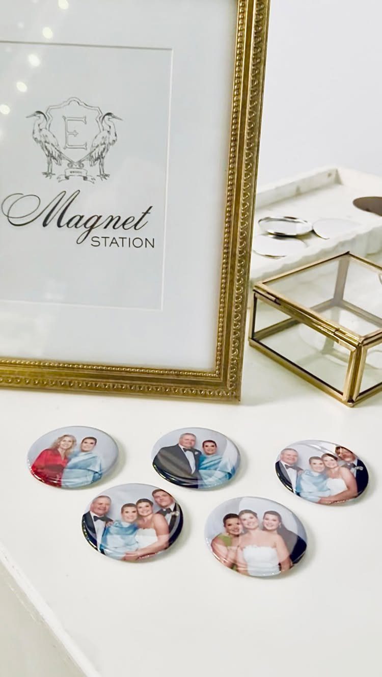 Round photo magnets of wedding couples next to a gold Magnet Station sign.