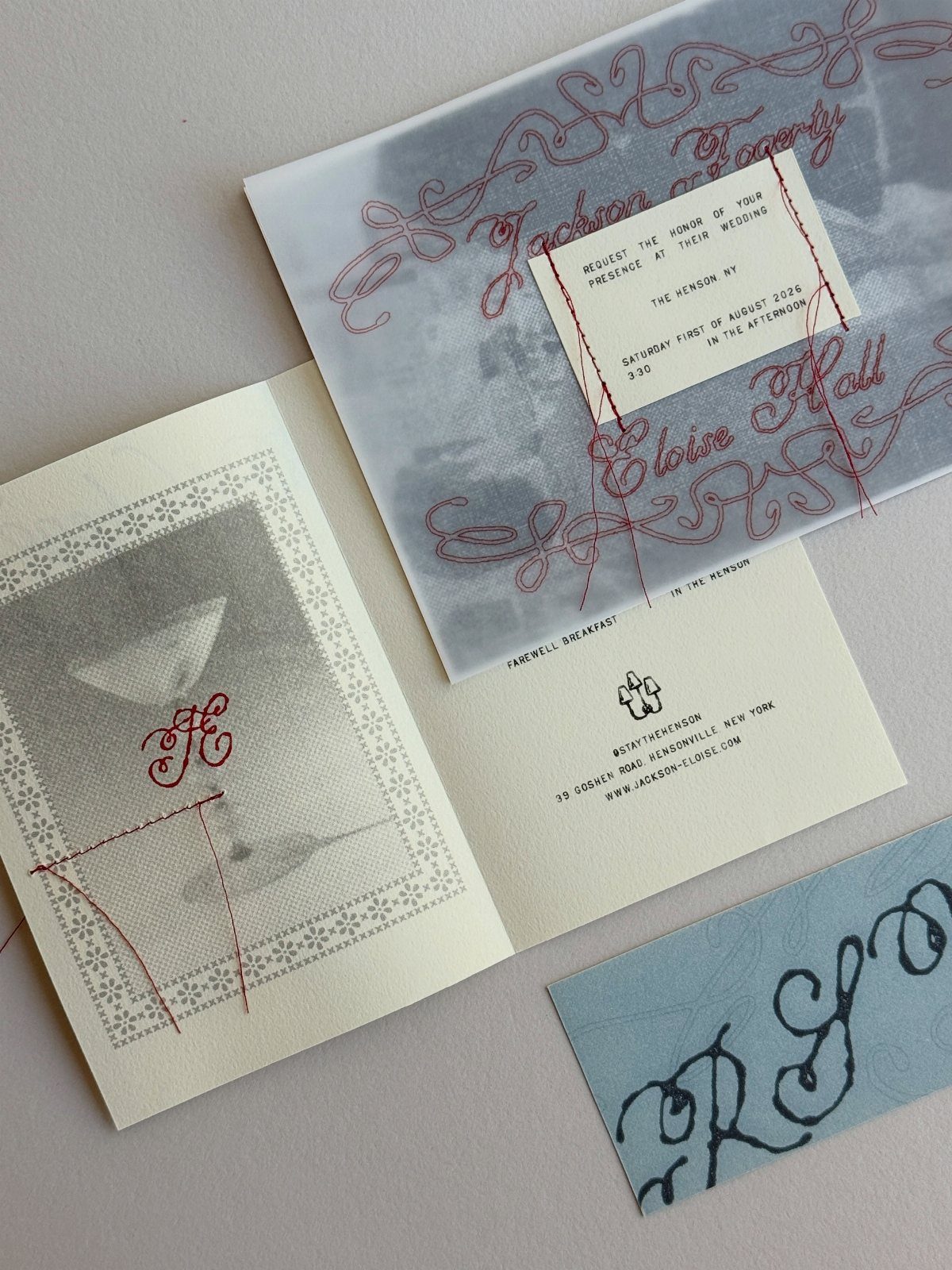 Wedding stationery set with vellum invitation, monogrammed card, and blue calligraphy card.