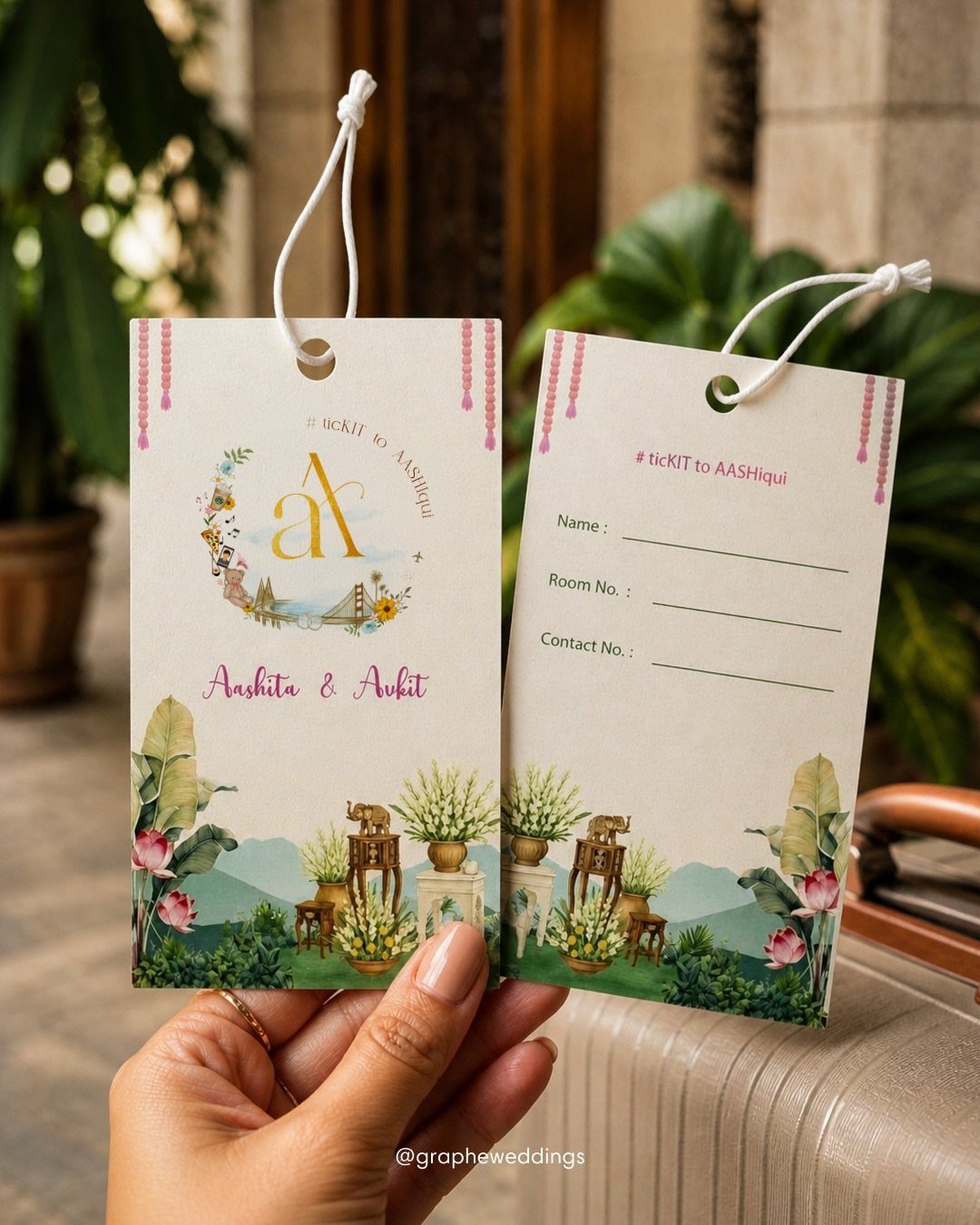 Two personalized wedding luggage tags with floral designs held over a tan suitcase.