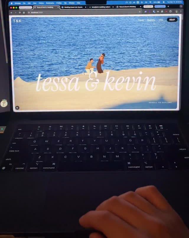 Laptop screen showing a wedding website with a couple on a sandy beach.
